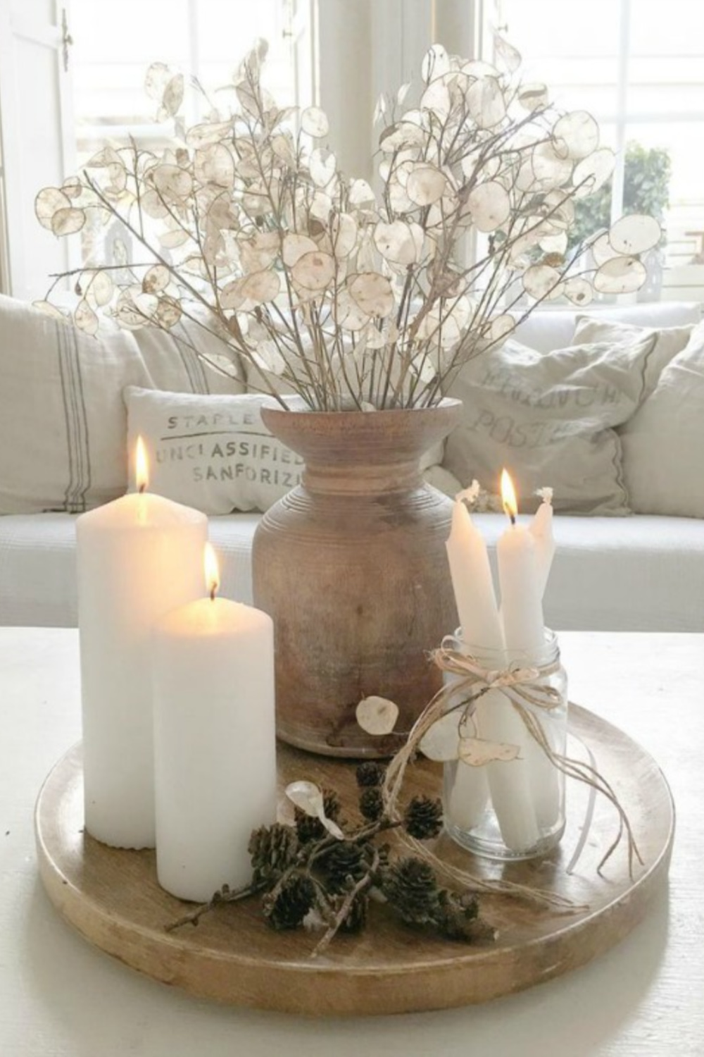 French Nordic living room vignette with lunaria, candles, pale colors, grain sack pillows, linen and serene style by Villa Jenal. #frenchnordic #livingroom #scandistyle