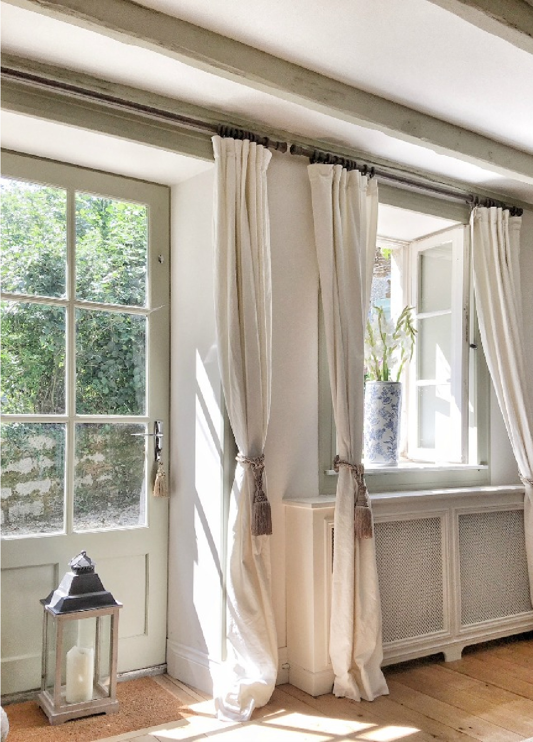 Pale Belgian linen curtains in a charming French country living room in France - Vivi et Margot.