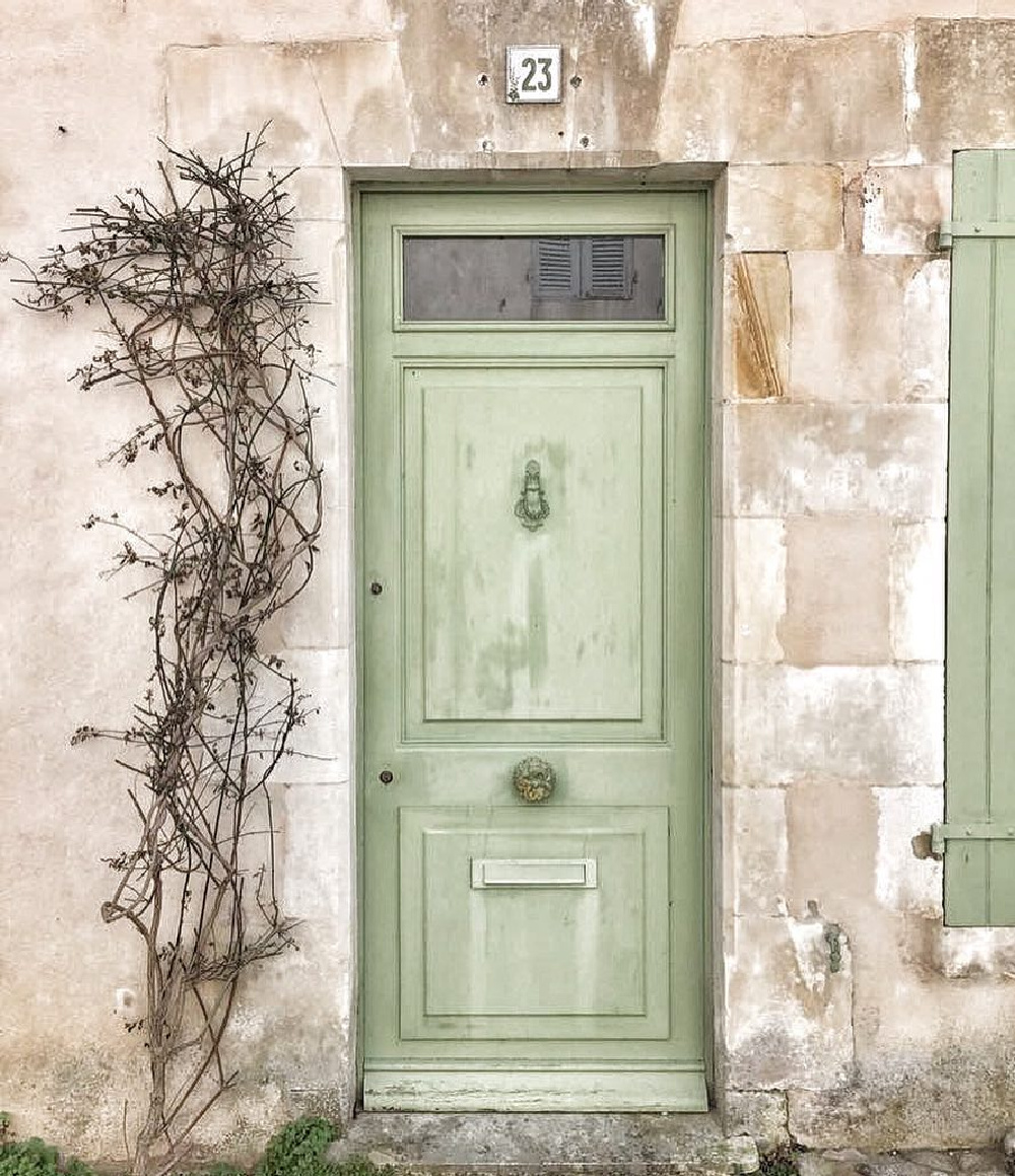 Traditional French green painted door on a rustic stone house in France - Vivi et Margot. #frenchcountry #greenfrontdoor #frenchgreen
