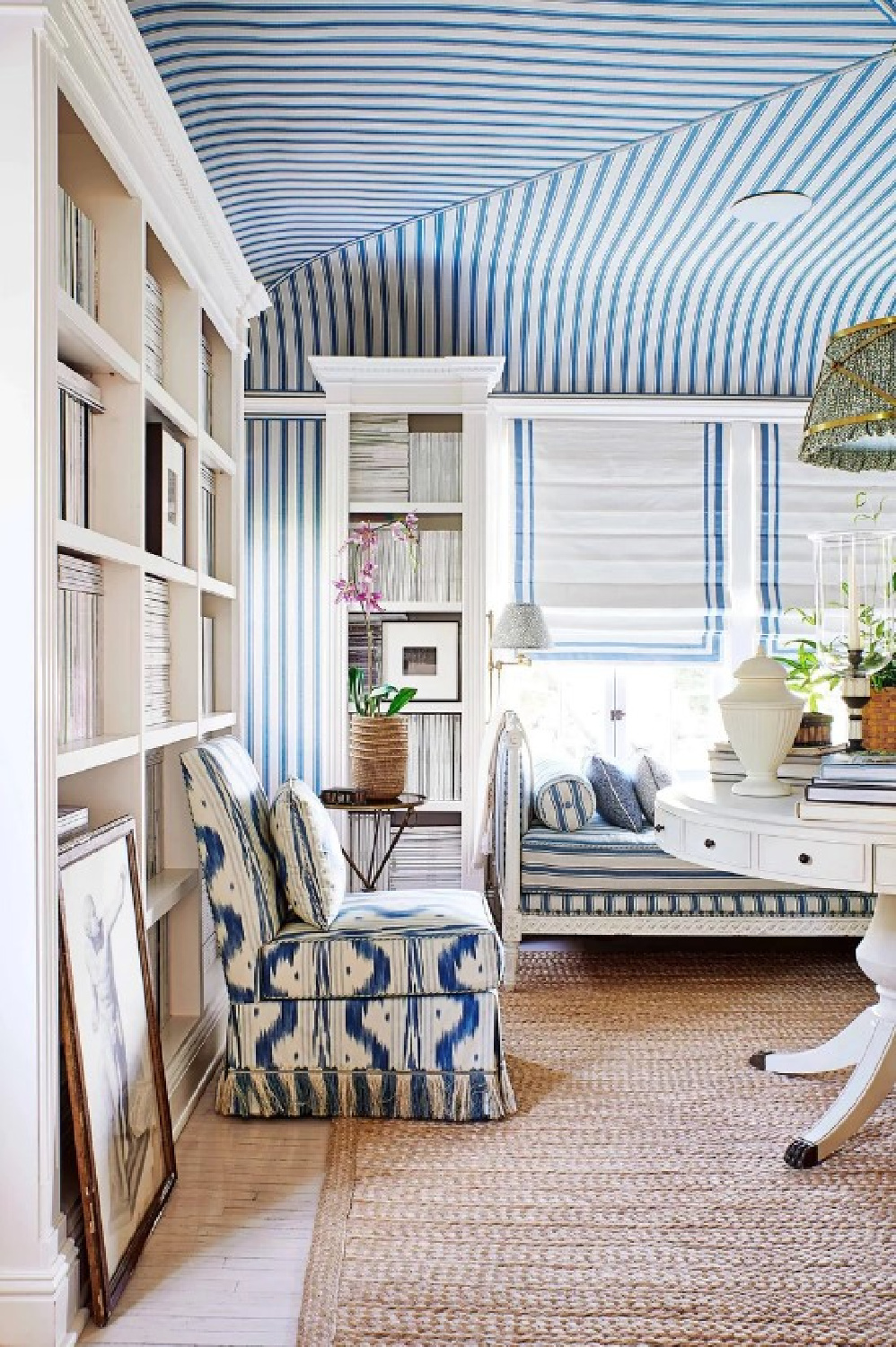 Mark Sikes designed blue room with stripe wallcovering on ceiling, daybed, and built-in bookshelves. From More Beautiful (Rizzoli, 2020) with photography by Amy Neunsinger.