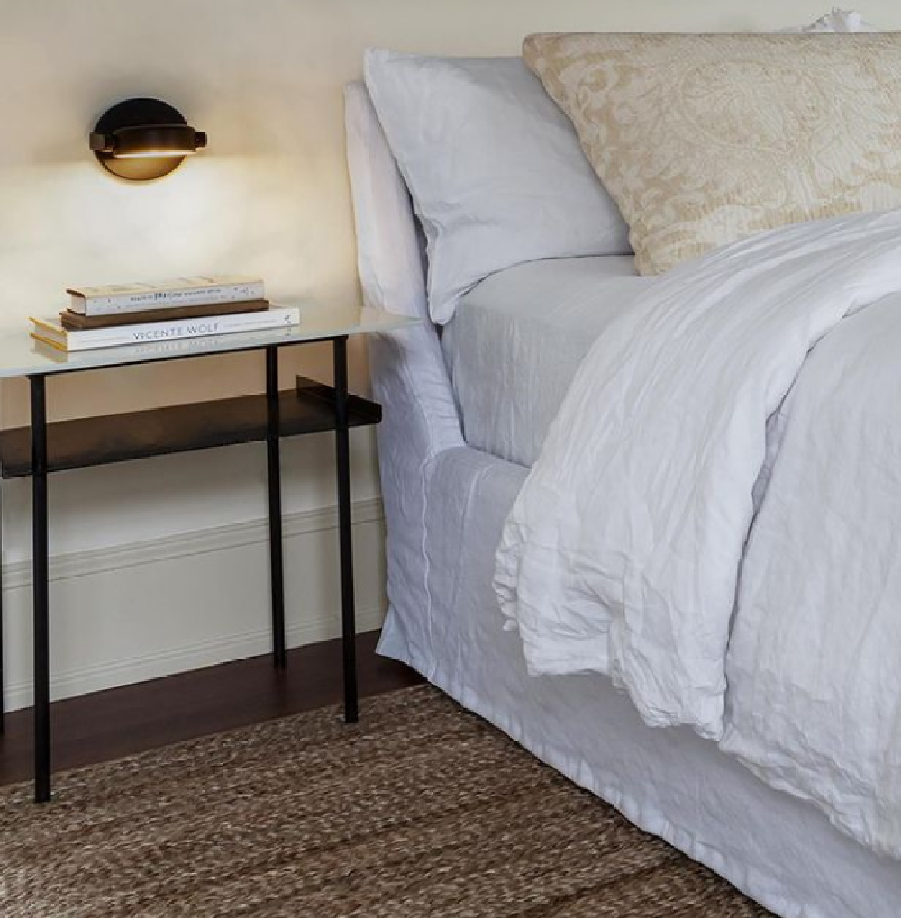 Sumptuous white linen on the bed in a timeless classic bedroom by Michael Del Piero. #bedroomdecor #whitelinen