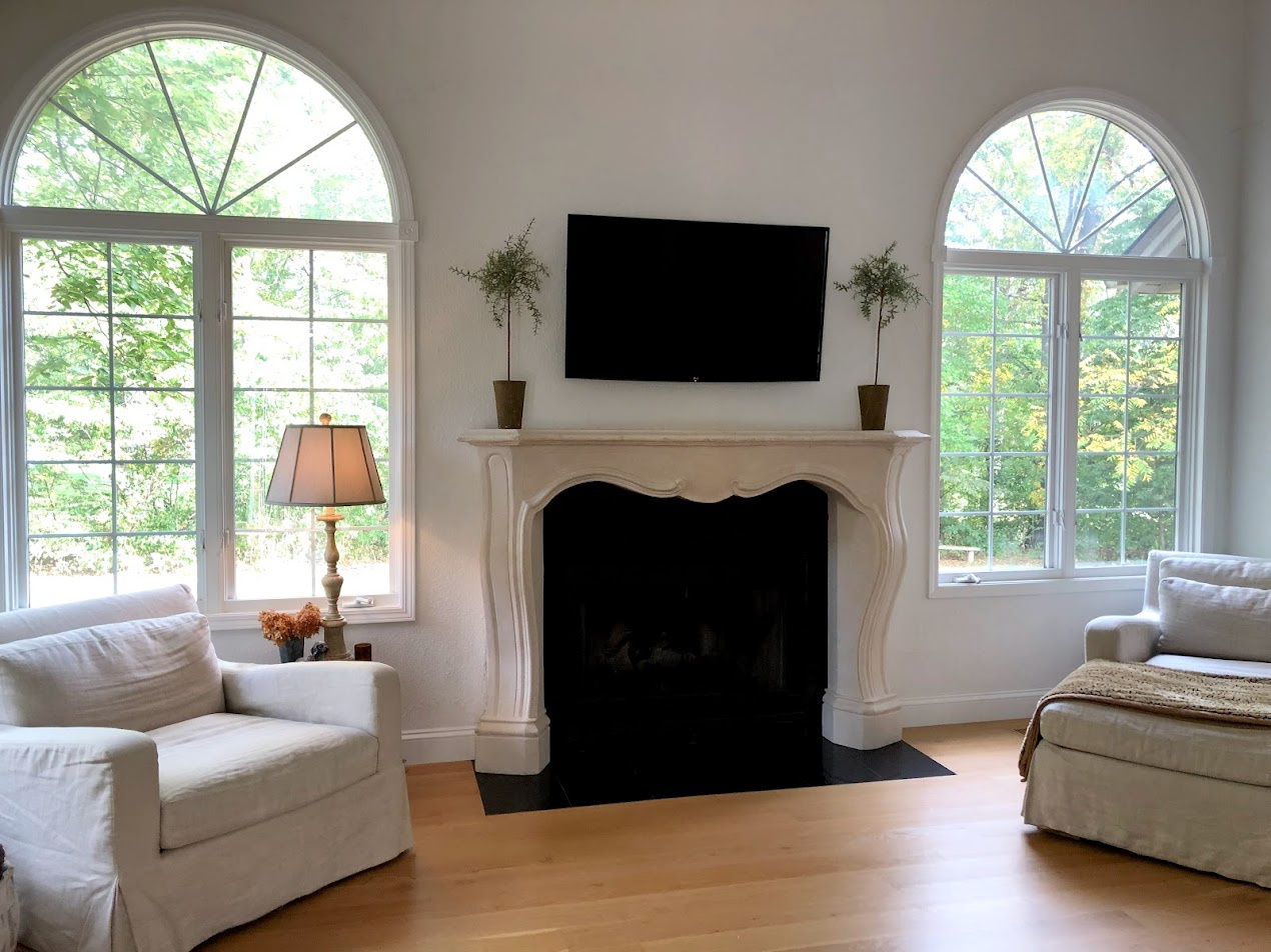 French country fireplace surround in our renovated fixer's living room - Hello Lovely Studio.