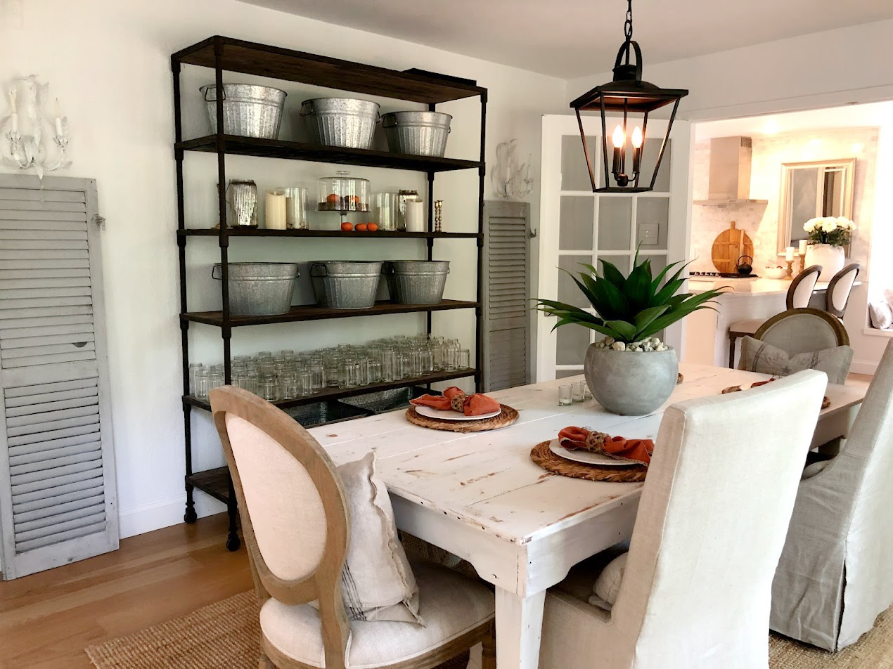 My casually elegant dining room with white farm table and coastal elements - Hello Lovely Studio. #coastalgrandmother #diningroom