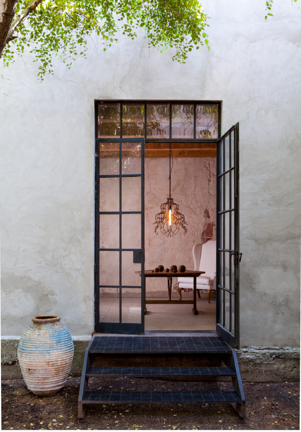 Industrial chic exterior and steel windows on a former charcoal factory converted to a residence with design by Michael Del Piero.