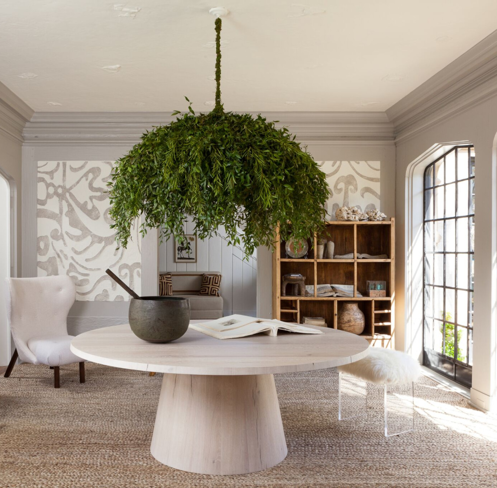 Botanical chandelier over a modern round dining table in a designer showhouse - Michael Del Piero.