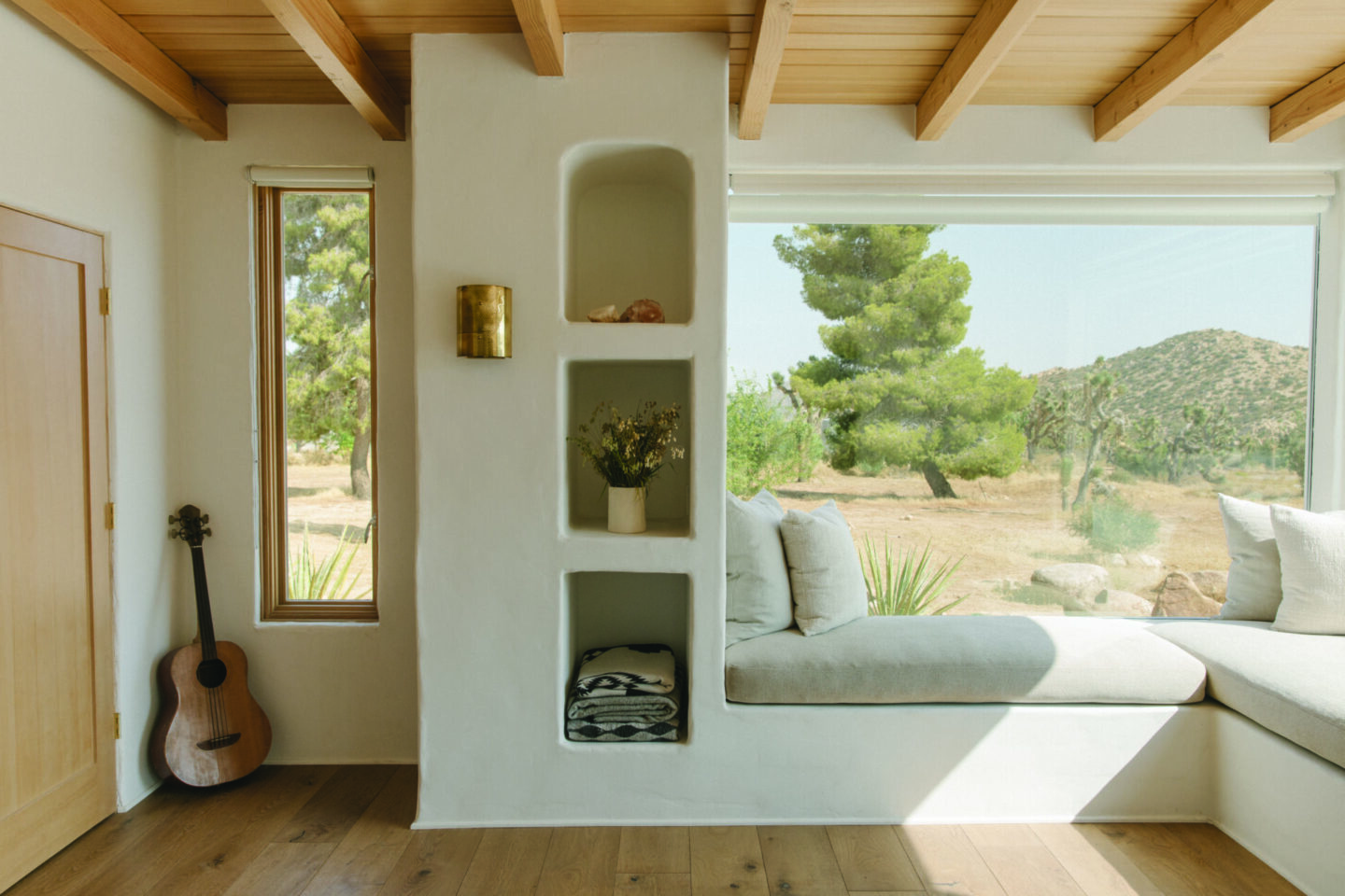 Minimal modern warm Sarah Solis designed interior in PACIFIC NATURAL AT HOME with window seat builtins. #californiacalm #pacificnatural