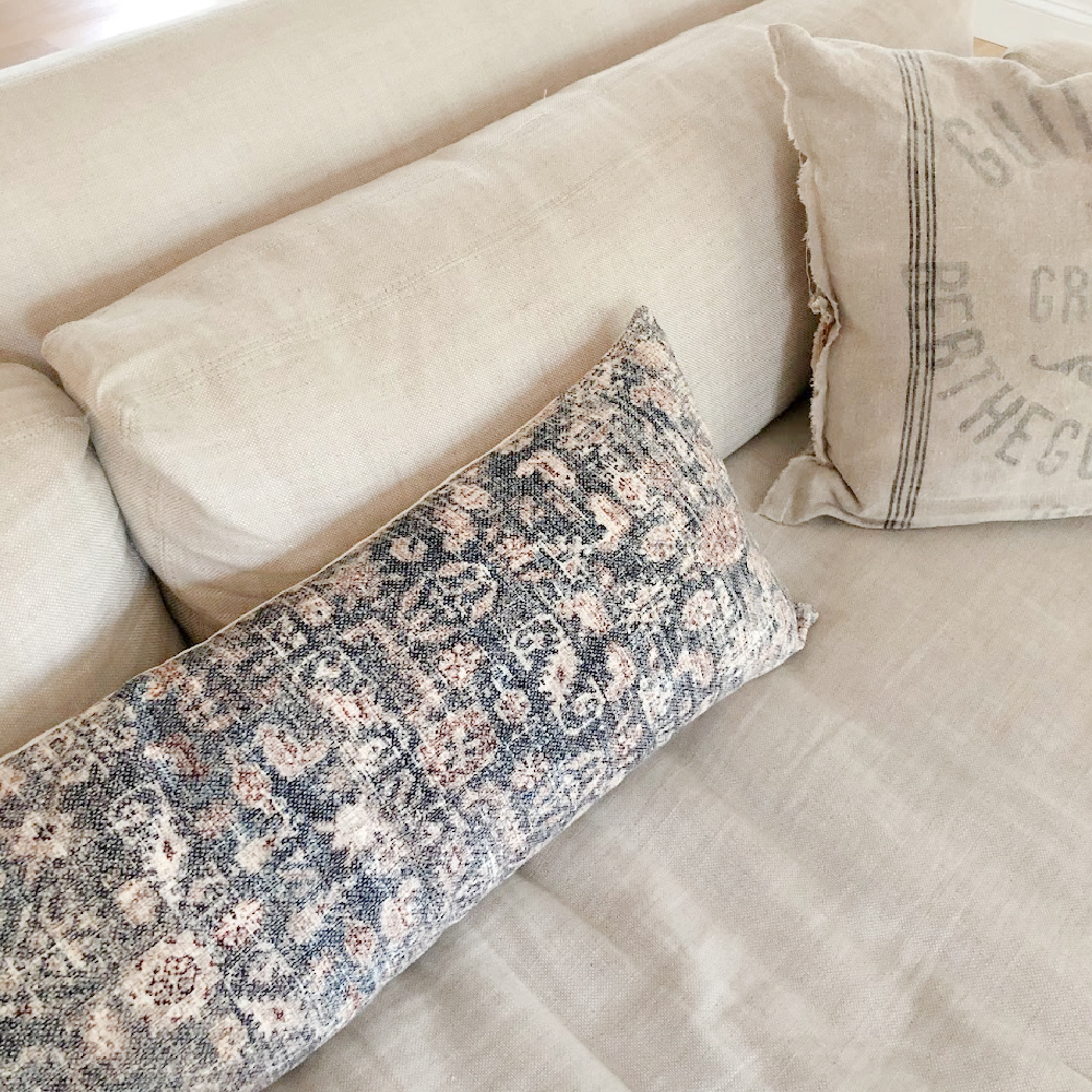 Montara pillow (Amber Lewis x Loloi) on my Belgian linen slope arm sofa by RH - Hello Lovely Studio.