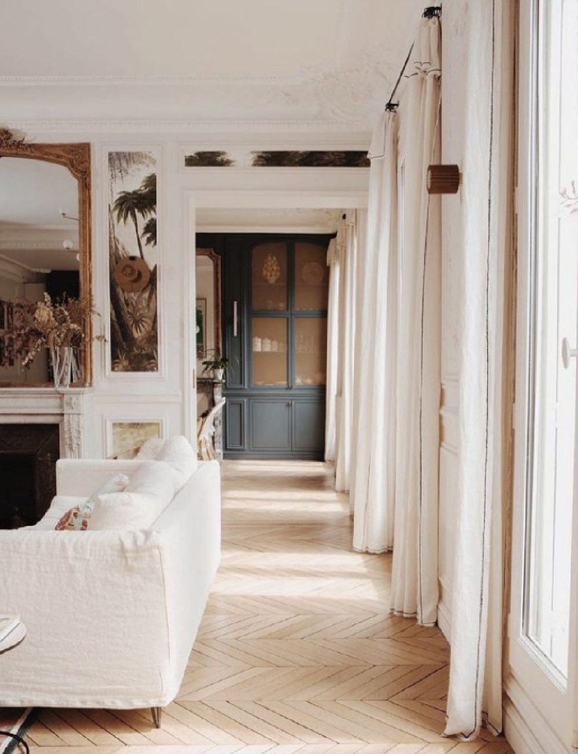 Herringbone wood flooring in an elegant French home with classic architecture - photo by Benjamin Colombel.