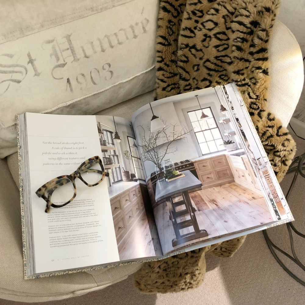 LIVING WELL BY DESIGN Melissa Penfold book on my cozy egg chair with animal print throw - Hello Lovely Studio