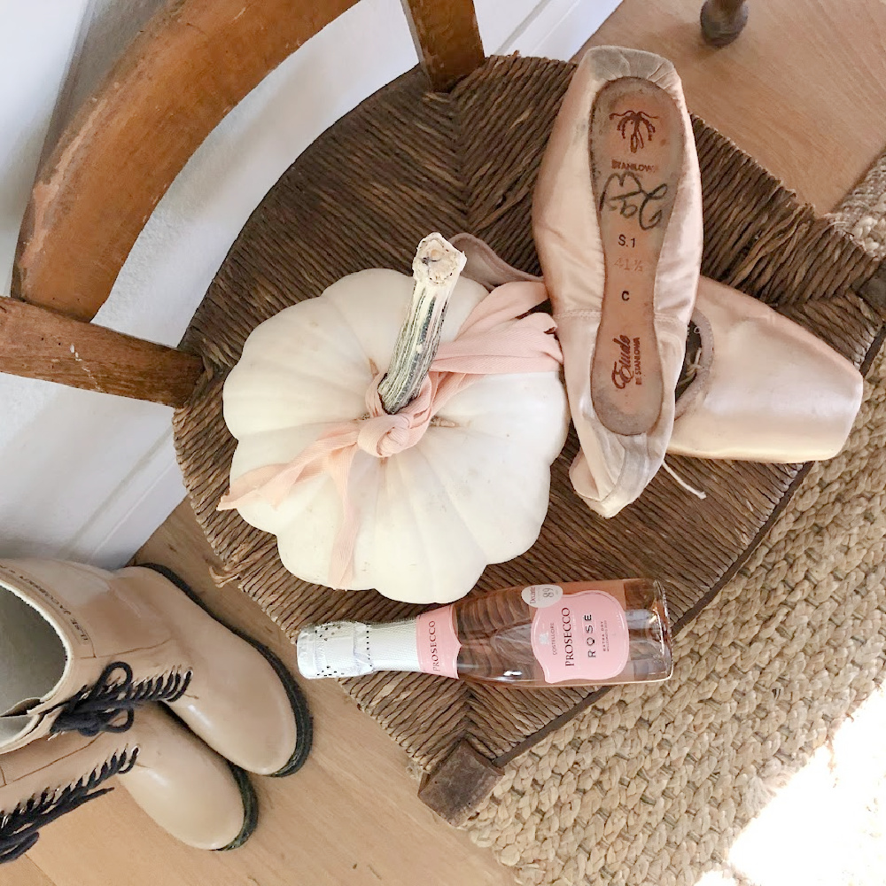 White pumpkin, pointe shoes, and Rose on a rush seat vintage chair - Hello Lovely Studio.