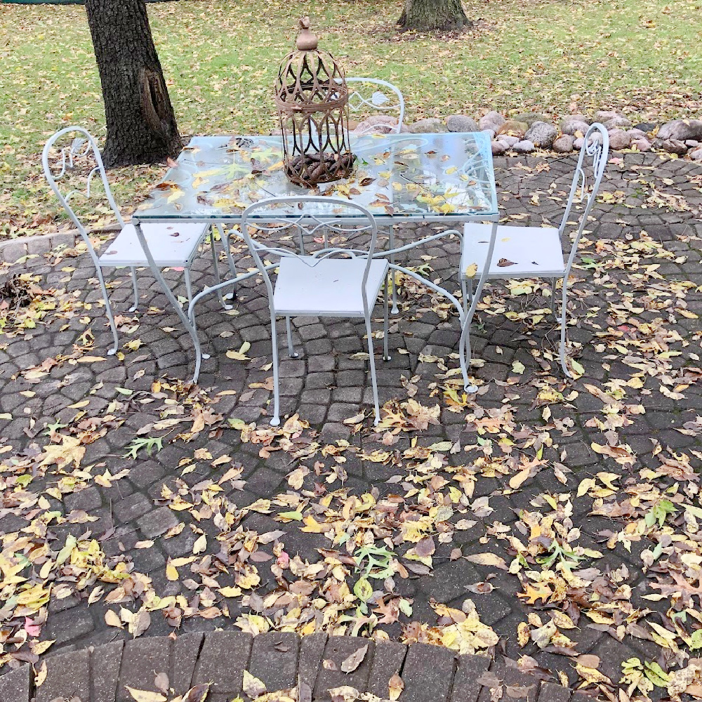 Yellow fallen leaves on my patio with vintage dining set - Hello Lovely Studio.