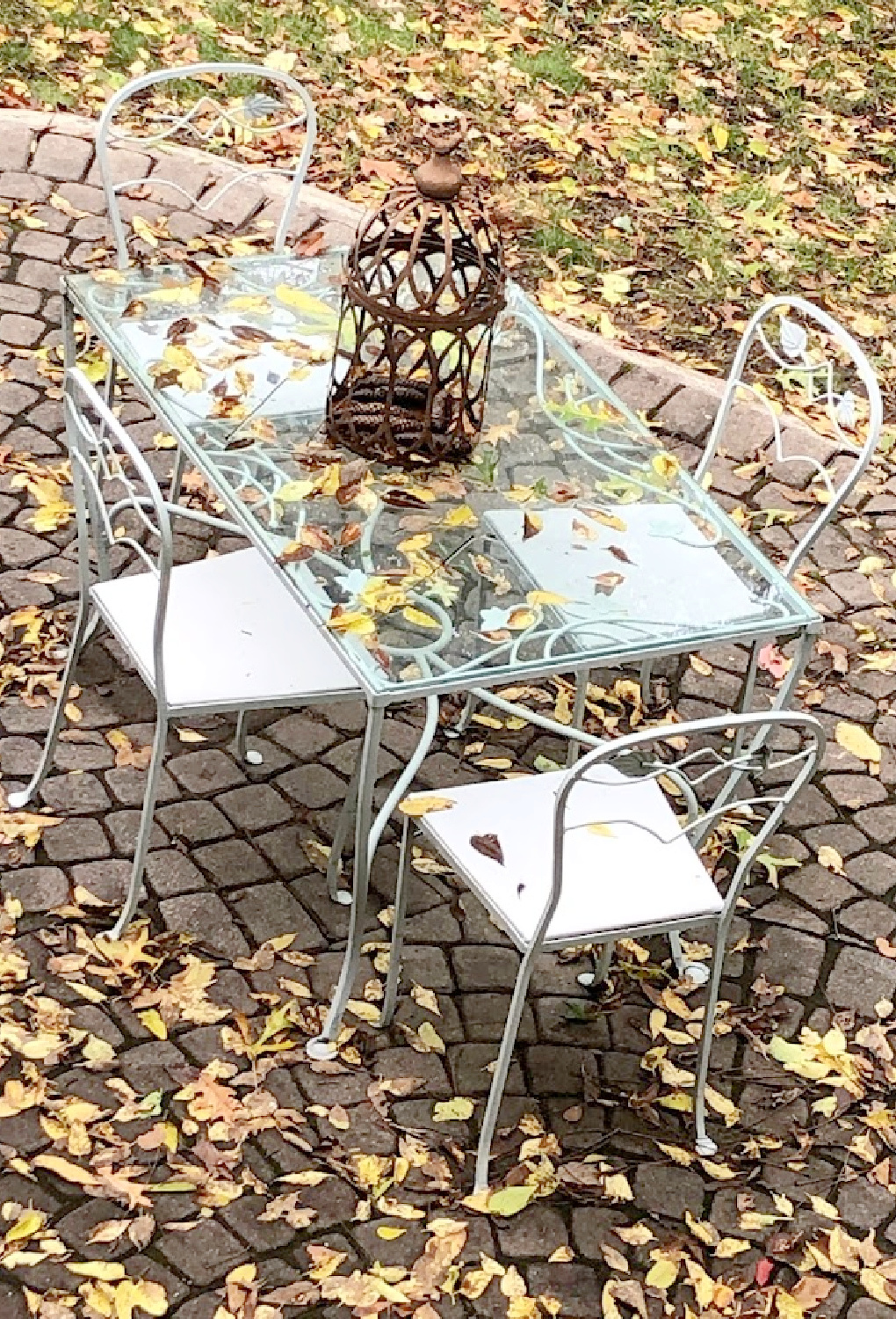 Yellow fallen leaves on my patio with vintage dining set - Hello Lovely Studio.