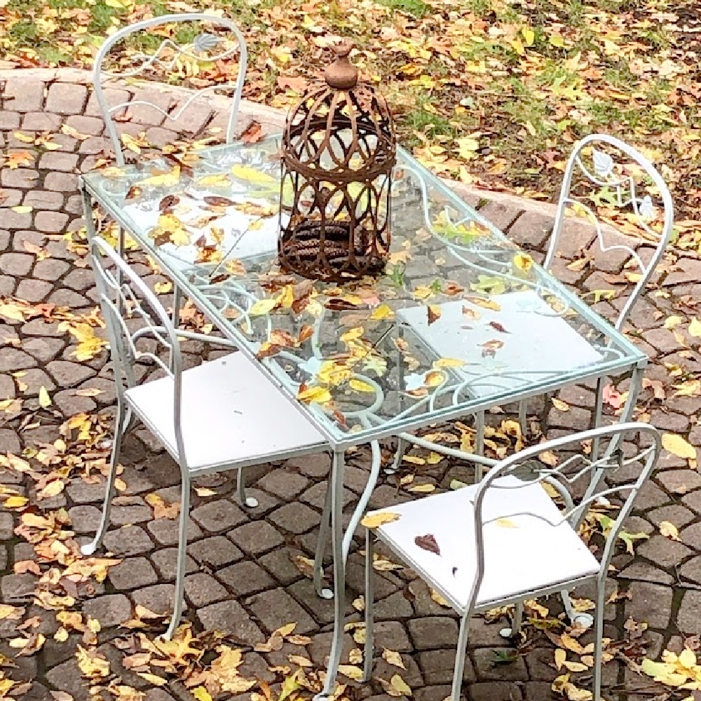 Yellow fallen leaves on my patio with vintage dining set - Hello Lovely Studio.
