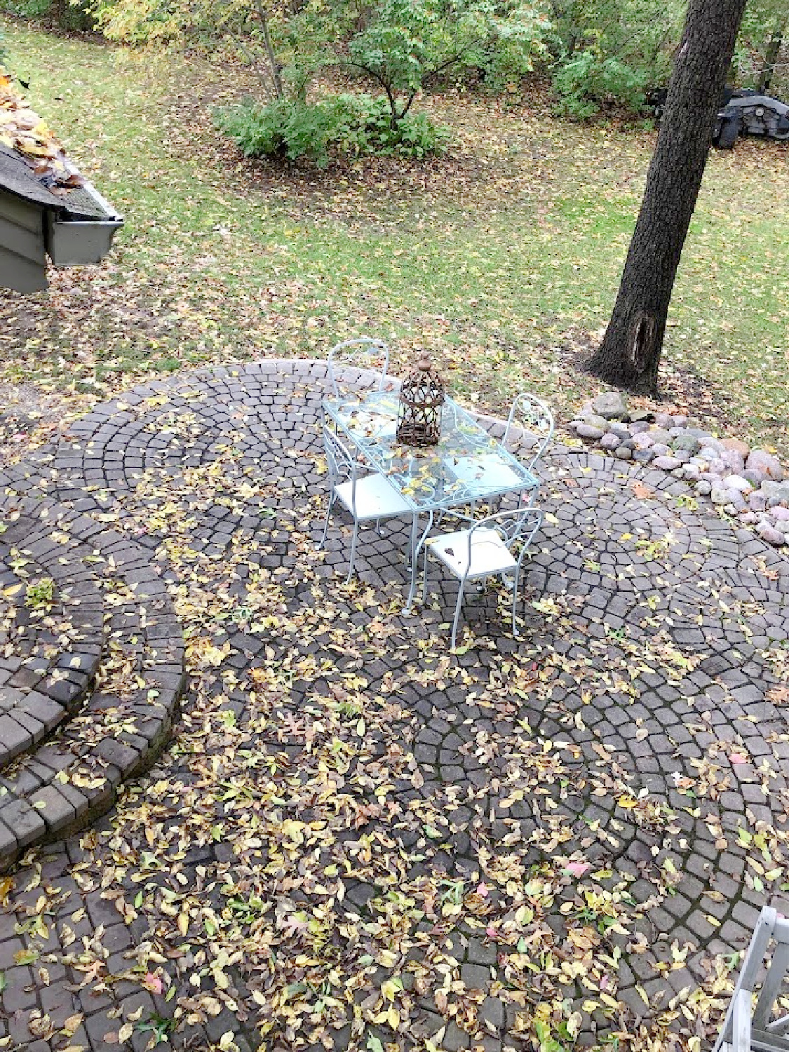 Yellow fallen leaves on my patio with vintage dining set - Hello Lovely Studio.