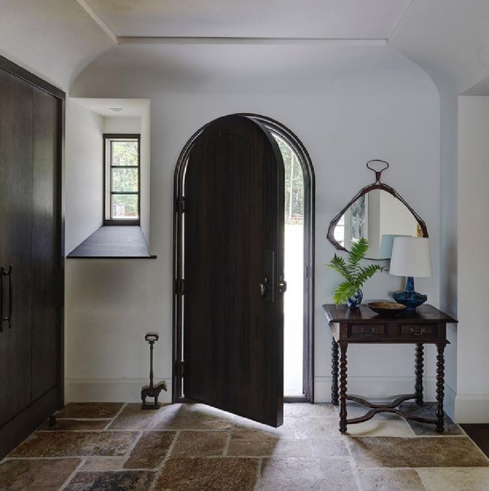 Breathtaking architecture in modern rustic entry with arched Old World door - interior design by Michael Del Piero.