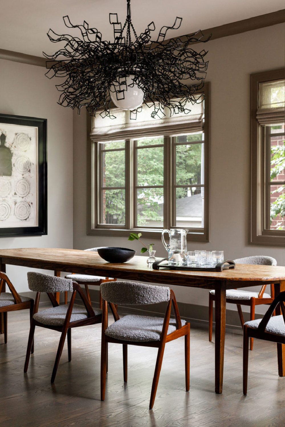 Modern rustic dining room with sculptural chandelier by Lucy Slavinski and interior design by Michael Del Piero.