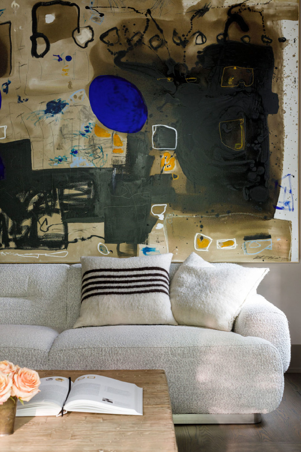 Bold saturated neutrals in a modern abstract painting in a living room designed by Michael Del Piero in Chicago.