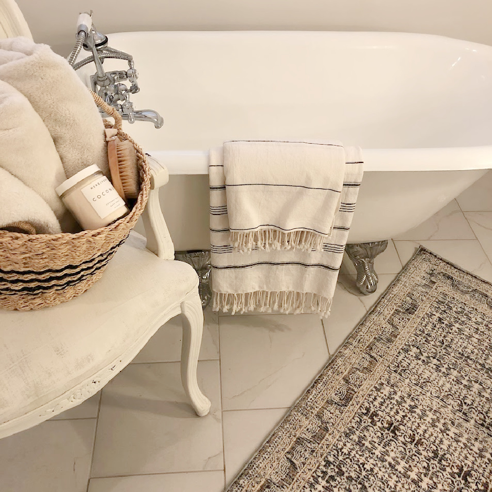 Amber Lewis x Loloi ocean multi area rug in my vintage style bath with clawfoot maid's tub - Hello Lovely Studio.