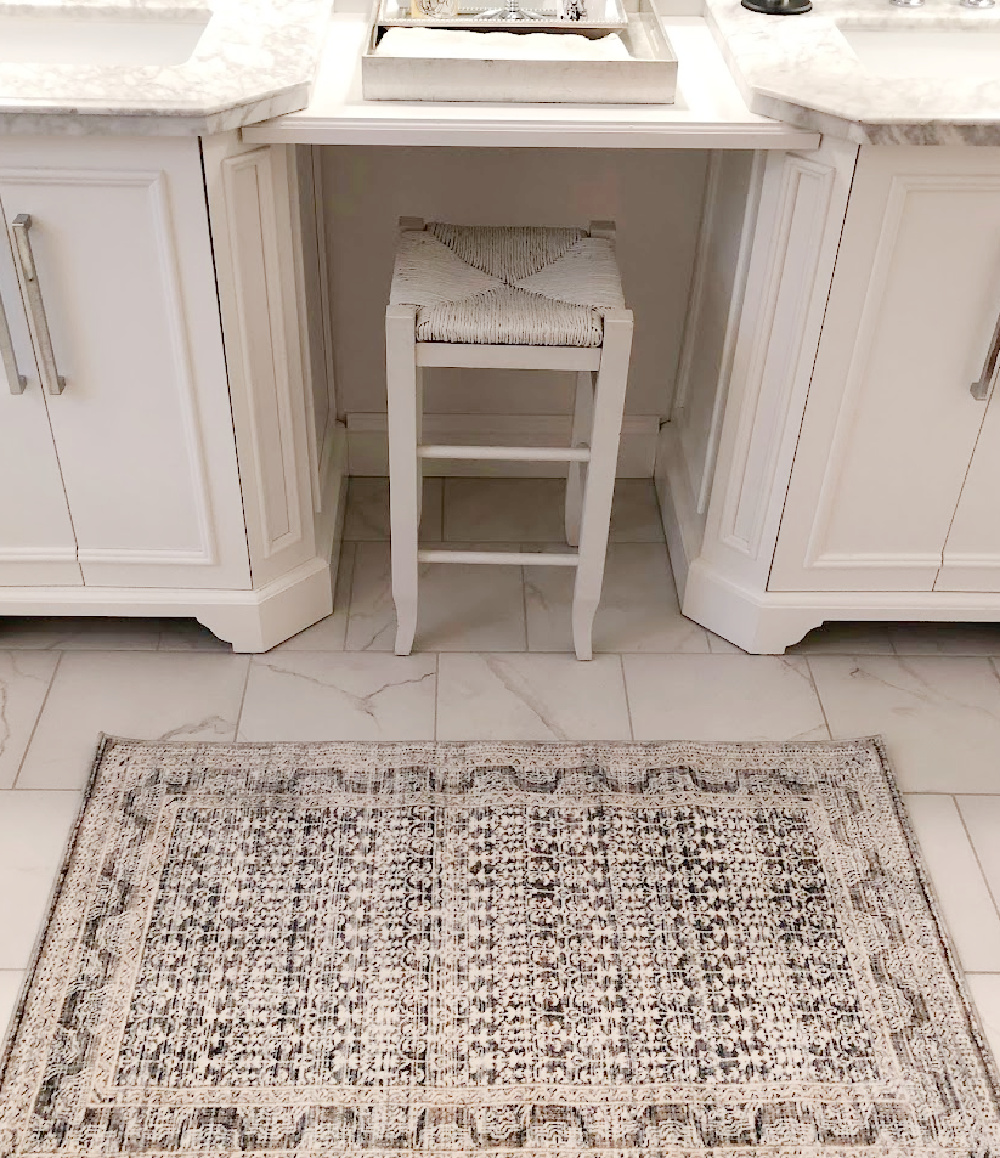 Amber Lewis x Loloi Zuma Zum ocean area rug in my bathroom with calacatta look porcelain tile - Hello Lovely Studio.