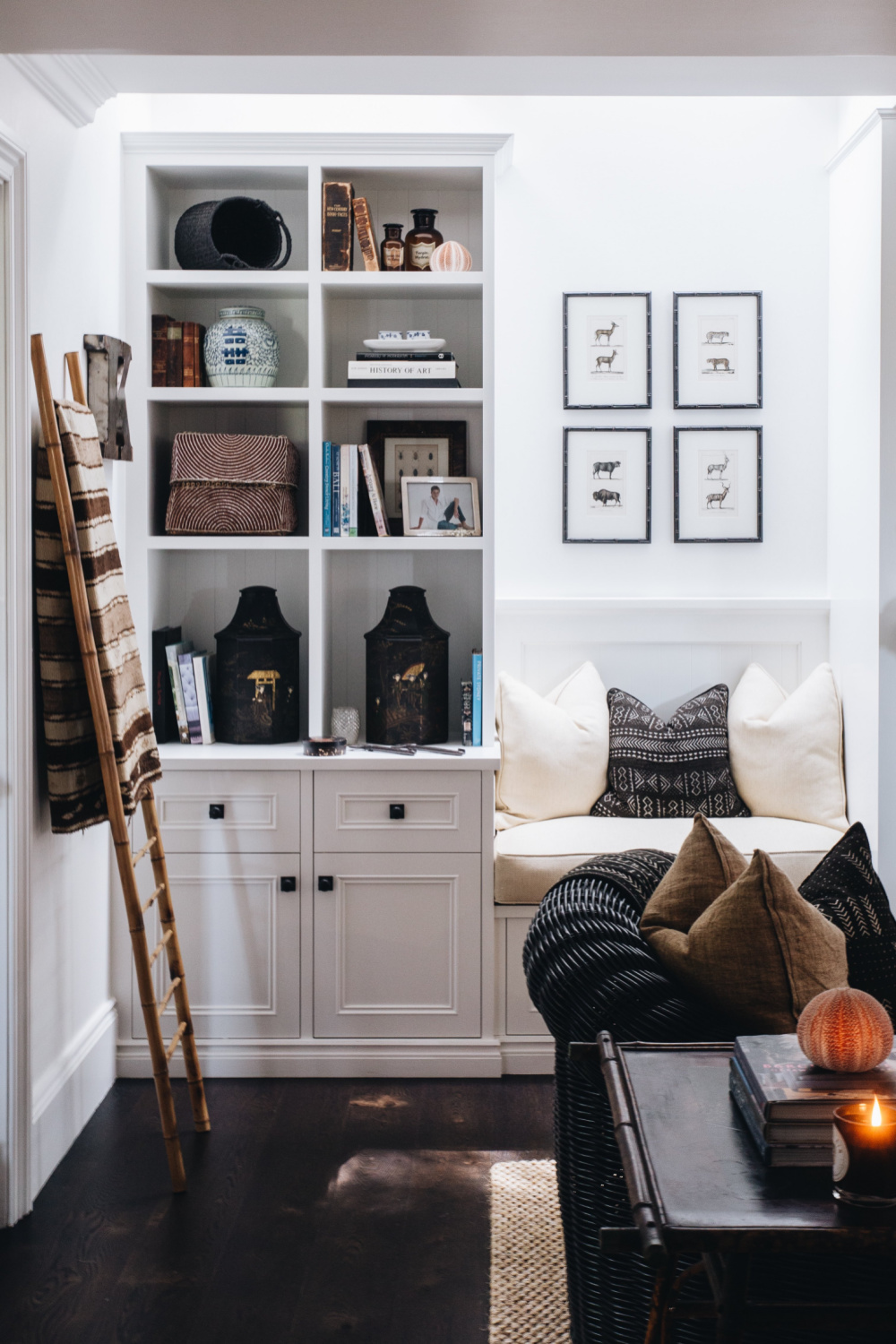 Sophisticated global style in a space with built-ins and design by Lynda Kerry. African tribal cushions, Chinese ceramic lamps, Indian lanterns, Indonesian chairs, bamboo tables.