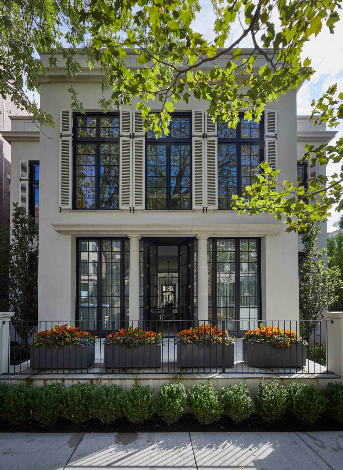 McAlpine House designed house exterior with windows reflecting cityscape - from Melissa Penfold's LIVING WELL BY DESIGN. #houseexteriors #mcalpinehouse #housearchitecture