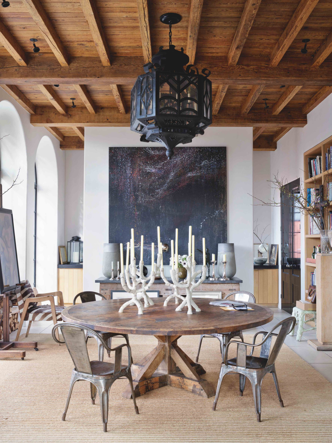 Alfredo Paredes designed parlor with rustic wood ceiling and round dining table in an East Village home. #newyorkhomes #aldredoparedes