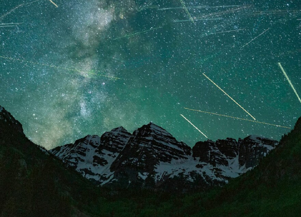 Time-lapse photo of peaks at Maroon Bells in the Elk Mountains, outside Aspen. The photo, It captures a buzz of air traffic in the night sky, From Pete McBride's book SEEING SILENCE. #naturephotography