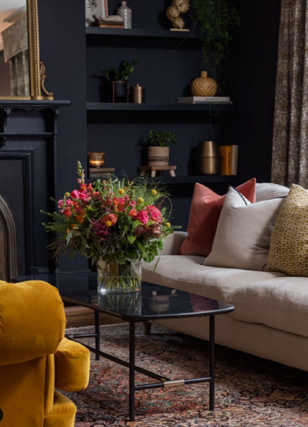 Farrow & Ball Railings black paint color in an English living room with fireplace - @tornandcottoninteriors. #railings #blackpaintcolors