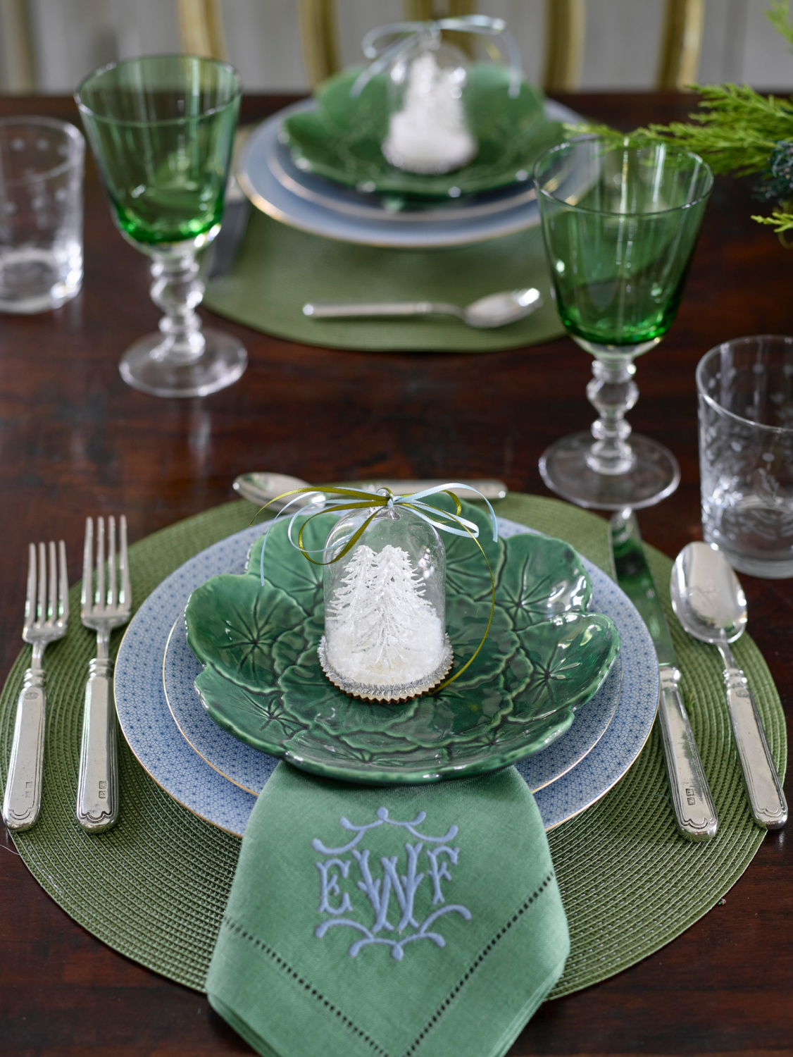 Atlanta Home for the Holidays Designer Showhouse Christmas placesetting by Liz Williams Interiors with a lovely snow globe at each plate.