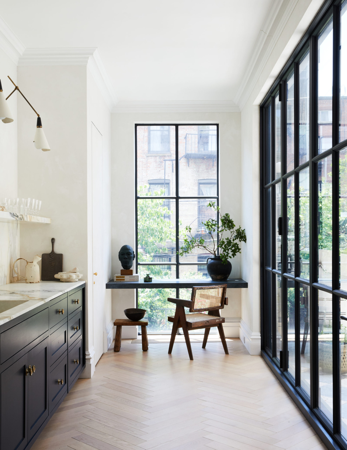 Athena Calderone Brooklyn kitchen with Farrow & Ball Railings blue black cabinets, marble, and floating desk in front of window. #blackkitchens #blackandwhite #inteiordesign