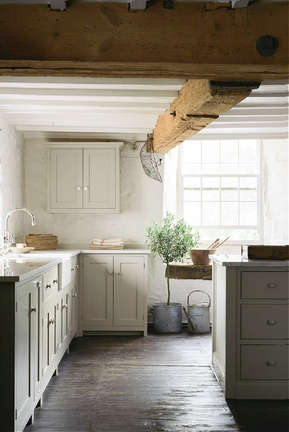 English country kitchen with beautiful bespoke design by deVOL. Rustic wood ceiling beams, custom Shaker cabinetry, and timeless style. #timelesskitchens