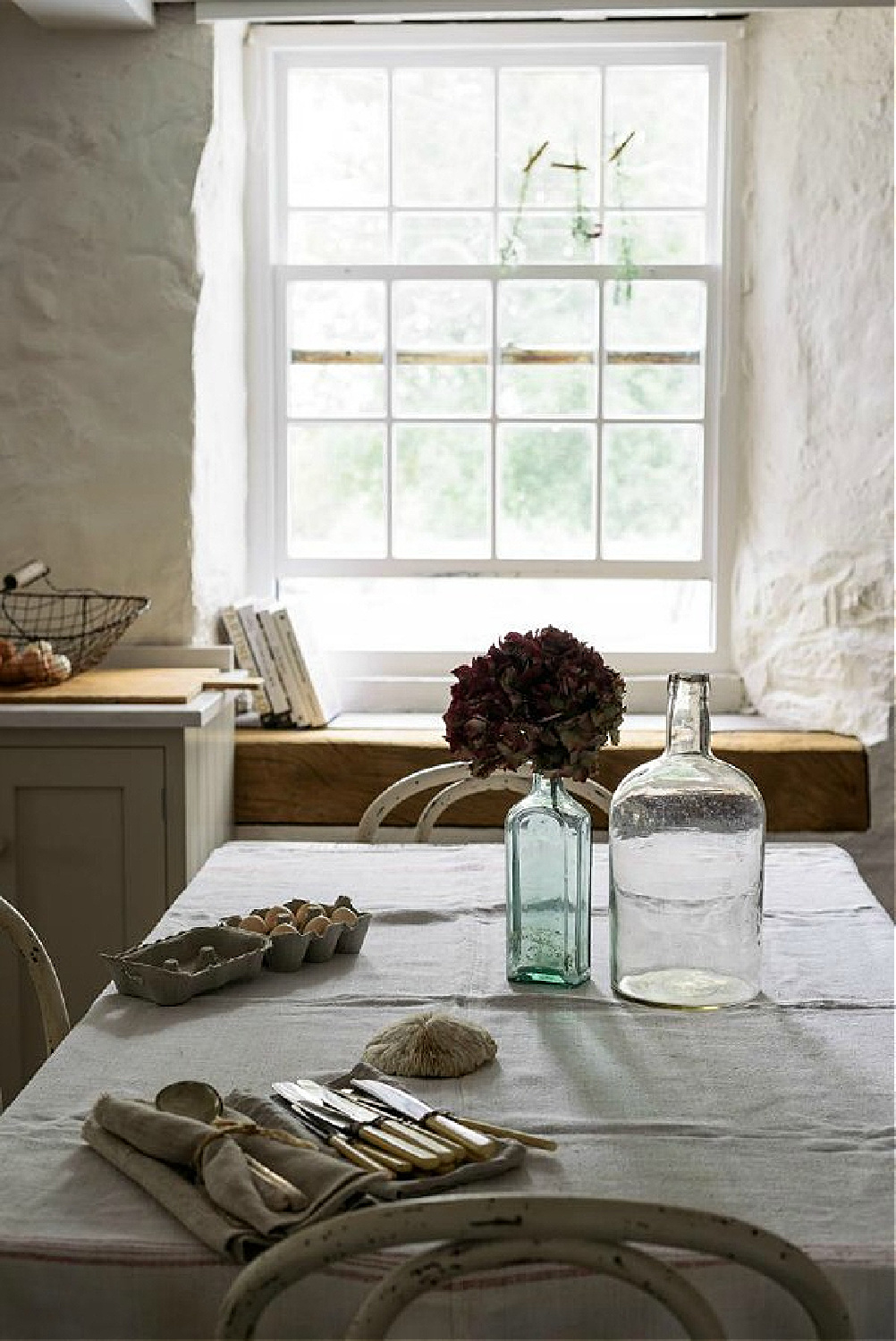 Beautifully rustic English country kitchen in the UK by deVOL has Shaker style cabinetry, farm sink, and rugged stone walls. #devolkitchens #oldworldstyle