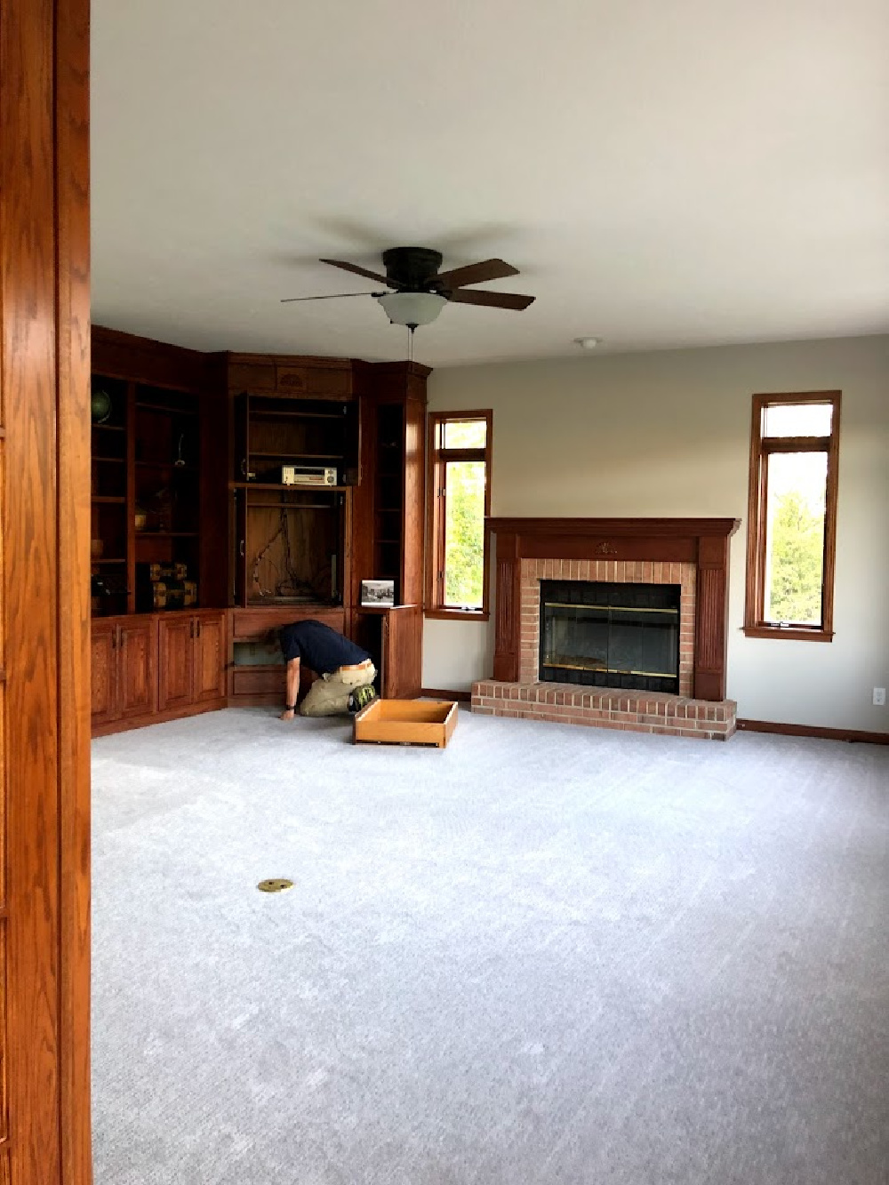 Our family room before it got its makeover with dark brown trim, ceiling fan, and builtins - Hello Lovely Studio.