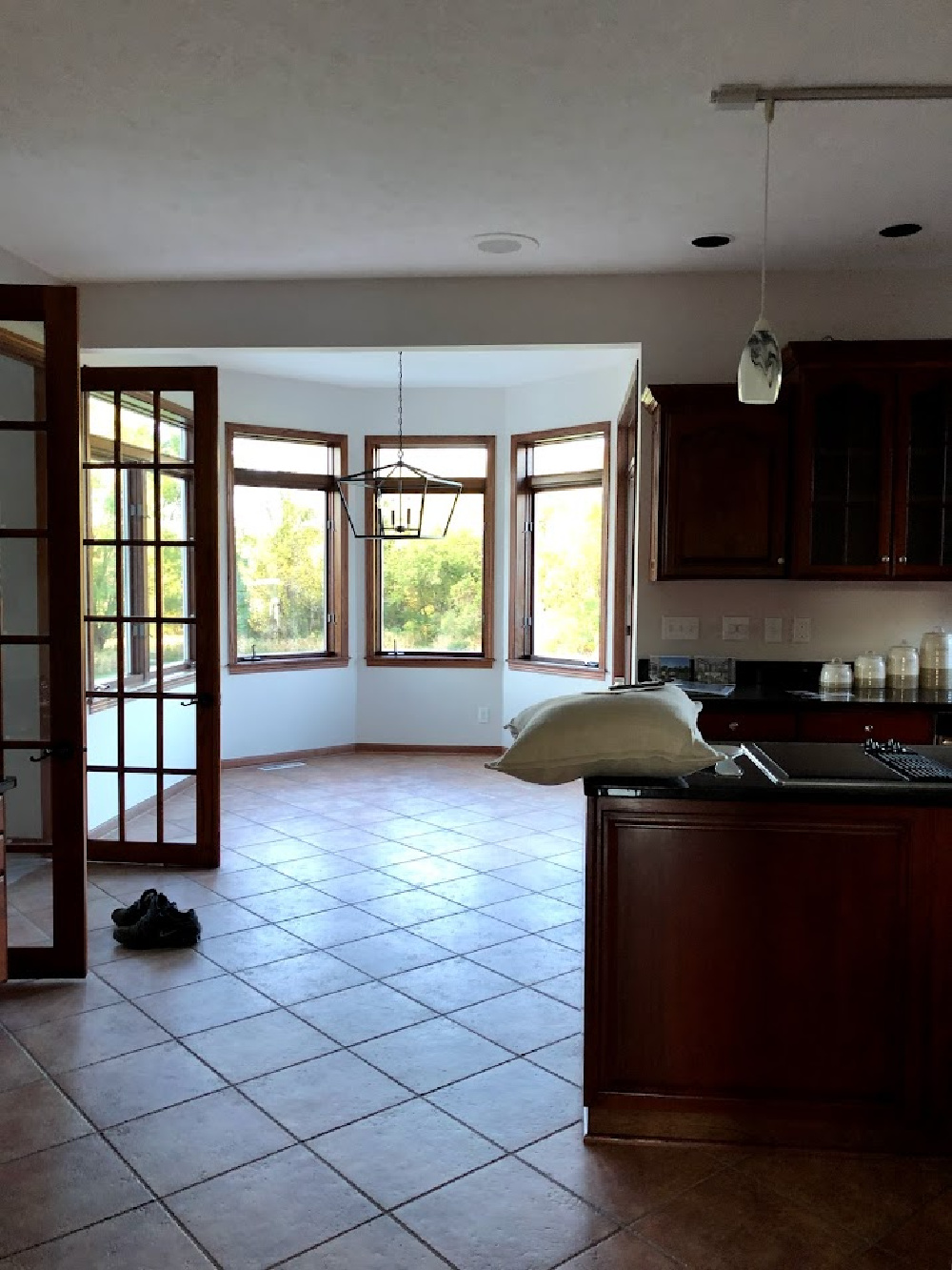 Oak trim French doors in breakfast room sun room to family room from kitchen before we renovated - Hello Lovely Studio.