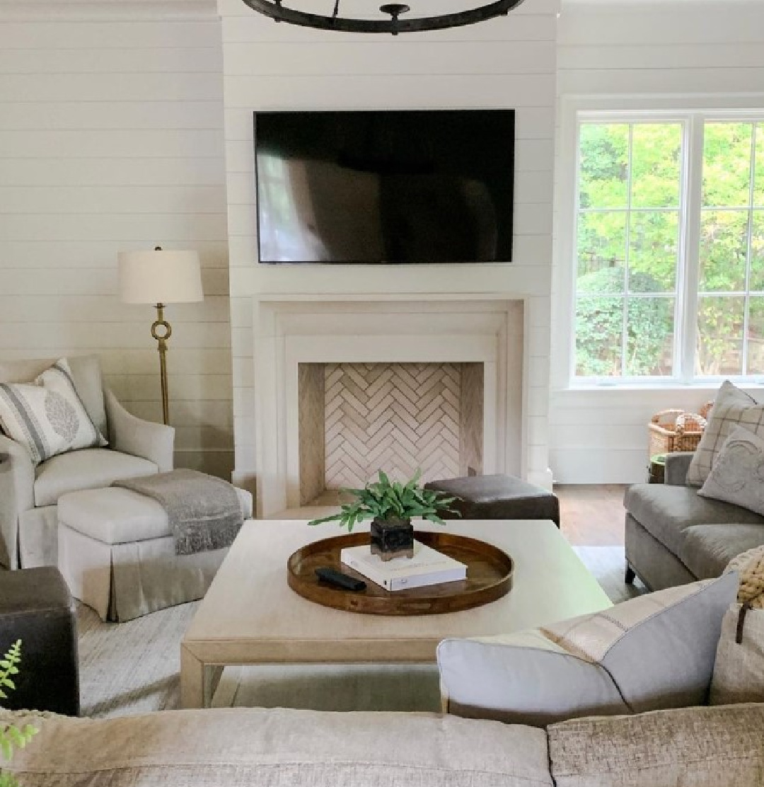 Benjamin Moore China White paint color in a French inspired living room with fireplace and pale color palette - Sherry Hart; Ladisic Fine Homes; Circa Lighting. #bmchinawhite