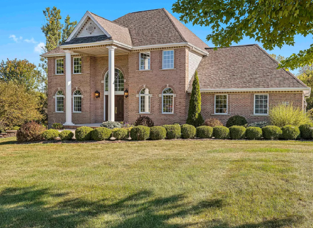 Brick Georgian style home with pillars at front porch - Hello Lovely Studio.