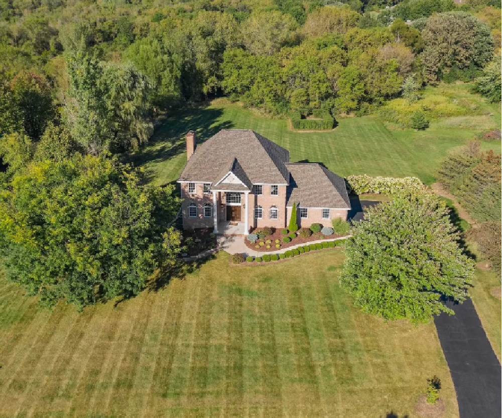 Aerial view of the red brick Georgian home on acreage we are renovating - Hello Lovely Studio.