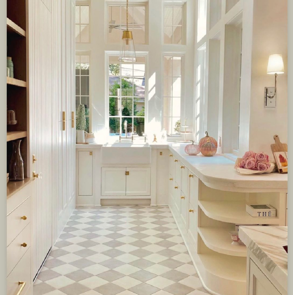 Warm white kitchen with brass hardware, checker tile floor and farm sink - Holly Bell Design. #whitekitchens #warmwhitekitchen