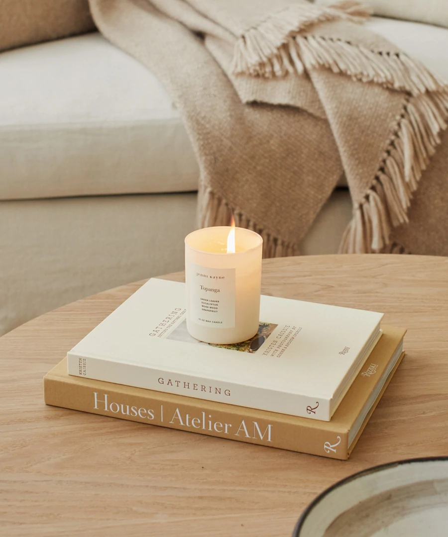 Topanga Glass Candle, Jenni Kayne on coffee table books including Gatherin gand Houses by Atelier AM.