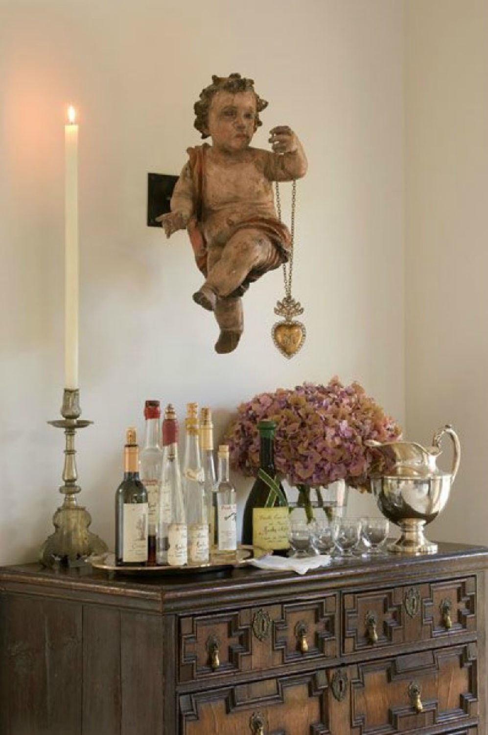 Exquisite cherub with ex voto heart in a lovely Santa Fe home - Photo by Peter Vitale for Milieu. #frenchcountry #europeancountry #oldworldstyle #interiordesign #cherub