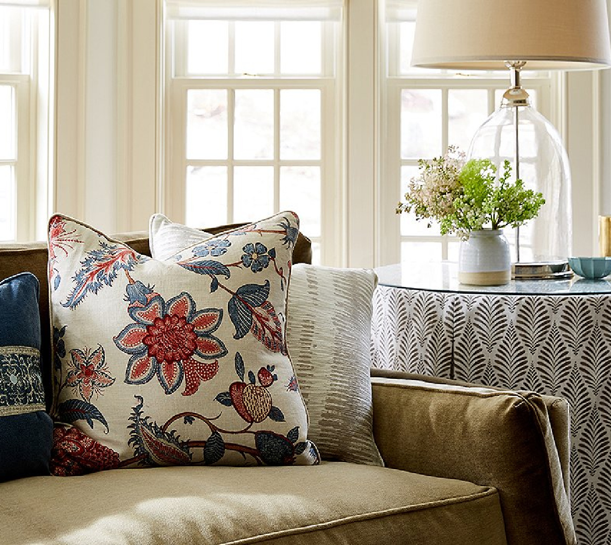 Detail of sofa, throw pillows, and skirted side table in OKL's idea house in Connecticut.