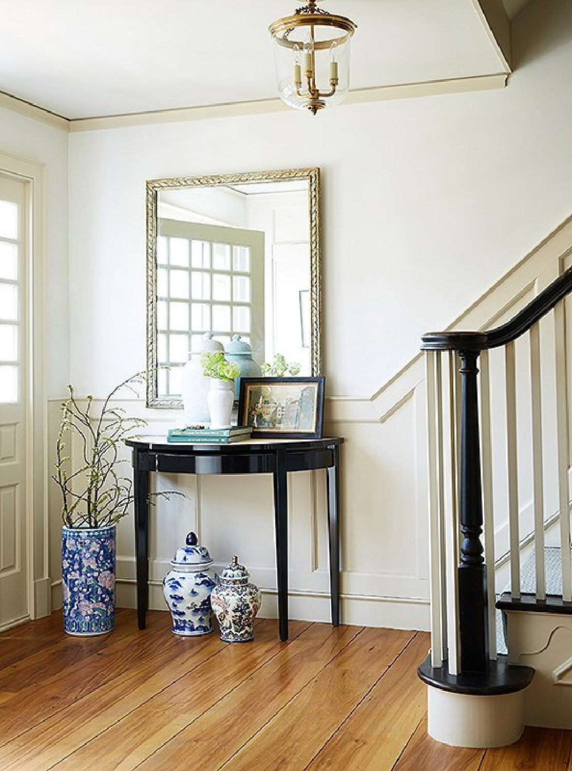 Classic entry in a New England farmhouse with Chinese porcelain near console table - OKL.