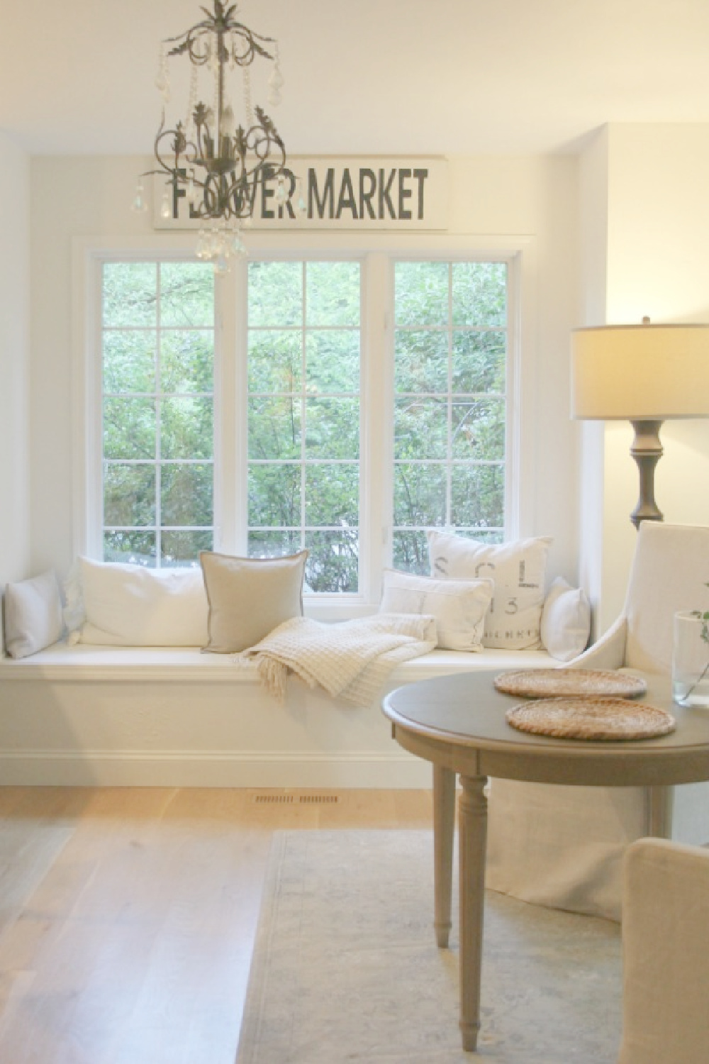 In our kitchen, I have sprinkled in Belgian linen upholstery and pillows to warm the white serenity - Hello Lovely Studio.