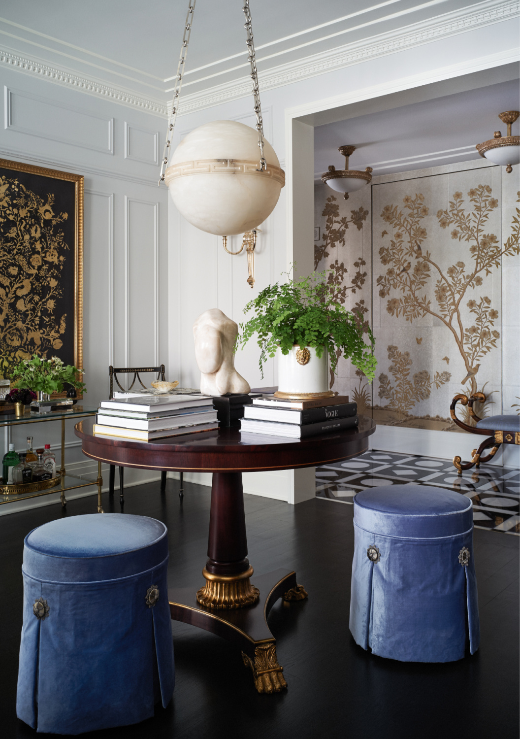 Summer Thornton designed luxurious and formal interior with skirted periwinkle velvet stools at round table. From WONDERLAND (Rizzoli, 2022). Photo by Bjorn Wallander. #summerthornton