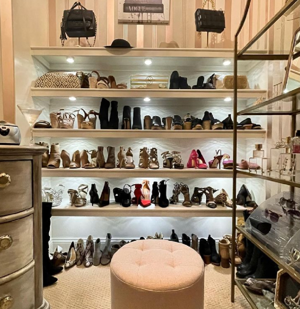 Dressing room and closet with wide shelves of shoes, dresser, and ottoman - @flightoffancyllc. #closetgoals #shoecloset #dressingrooms