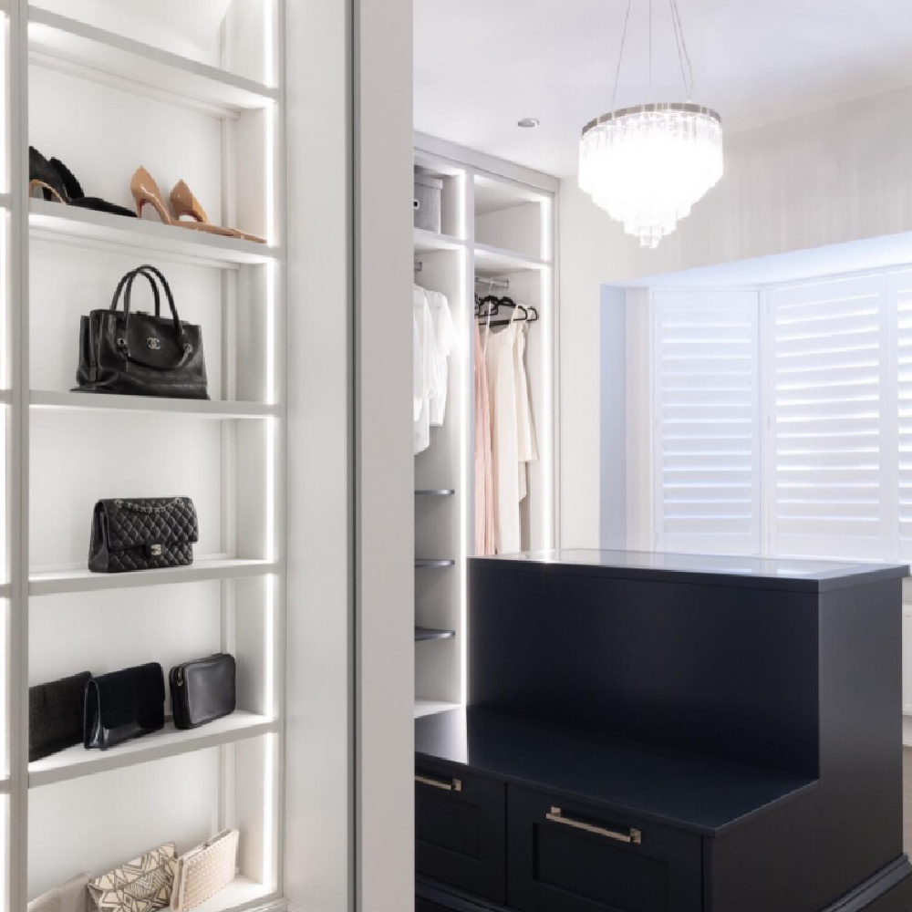 Beautiful custom closet with window, chandelier, island, and bespoke details - @johnlewisofhungerford. #customcloset #luxurycloset #dressingrooms