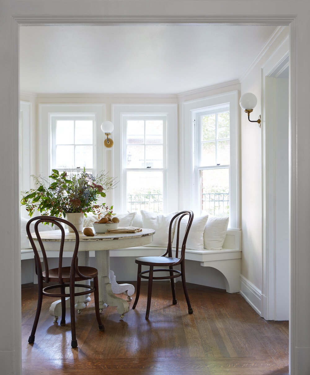 Delicate White (PPG paint color) in a beautiful breakfast nook with bay window - Leanne Ford design.