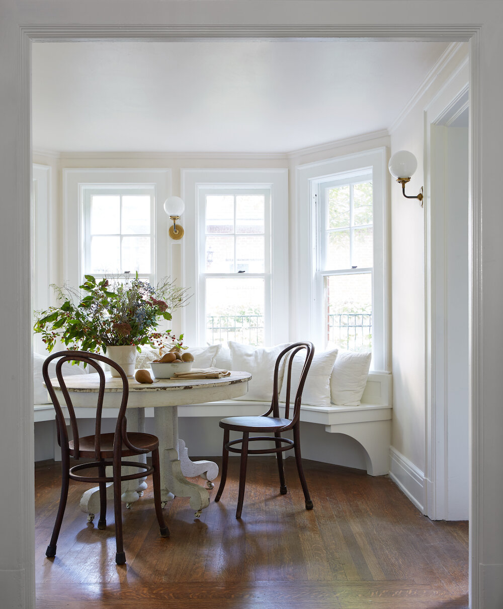 Vintage style in a breakfast nook with curved banquette and Bentwood chairs - Leanne Ford Interiors.