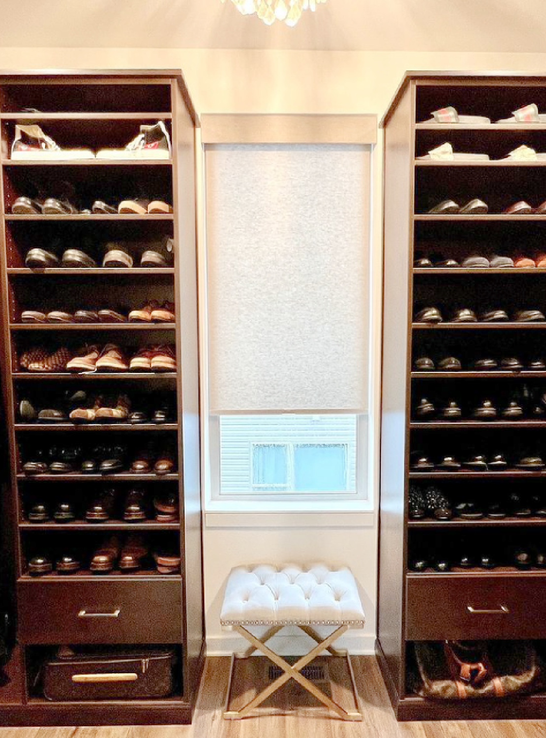 Luxurious closet with window and shoe towers flanking it - @terrisdesignswork. #luxurycloset #shoestorage #closetgoals