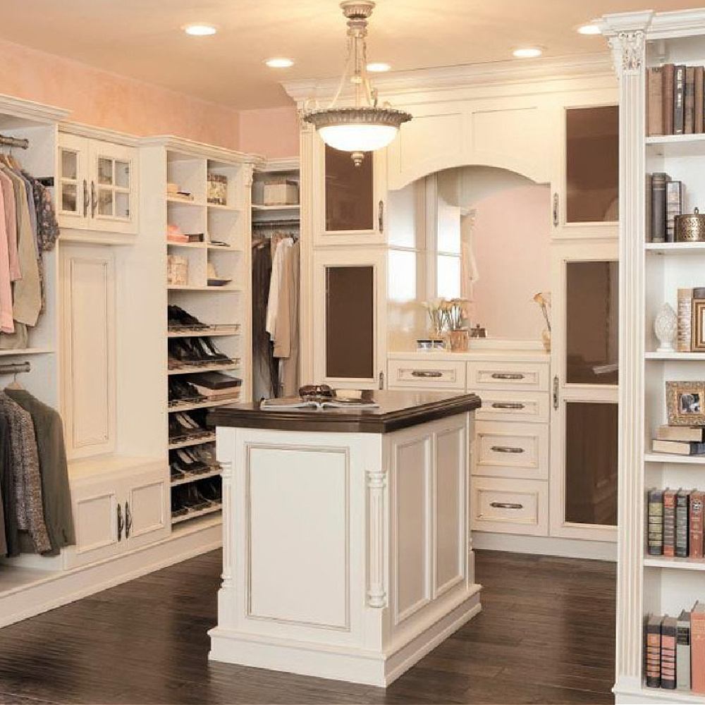 Luxurious closet with island and white millwork - via @thejudyo. #dreamcloset #closetwithisland #dressingrooms